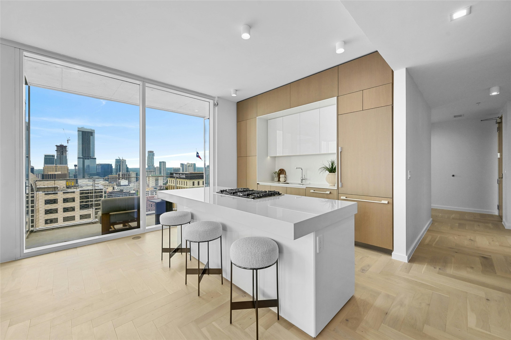 313 West 17th Street, Unit 1807 Austin, TX 78701 - Photo 3 of 39 The kitchen is designed with a sleek, minimalist aesthetic, including cabinets that blend seamlessly into the walls, ensuring a clean and unobtrusive appearance. Plus, you can enjoy the panoramic city view while cooking or baking, adding to the kitchen's charm and functionality.