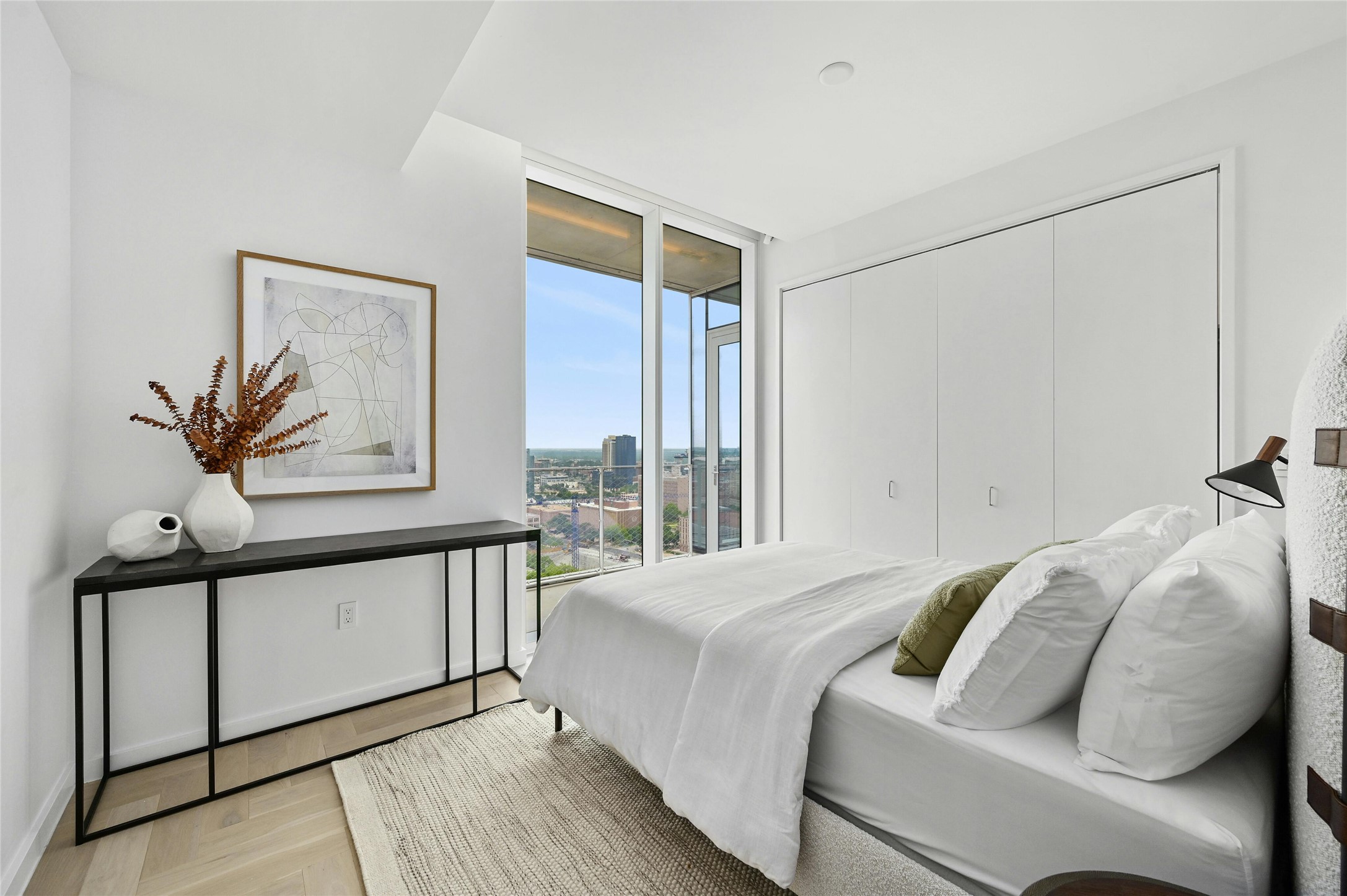 313 West 17th Street, Unit 1807 Austin, TX 78701 - Photo 8 of 39 The second bedroom offers ample storage space and features a glass panel view terrace, providing a blend of functionality and scenic views.