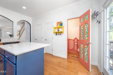 a view of a hallway to a livingroom with furniture