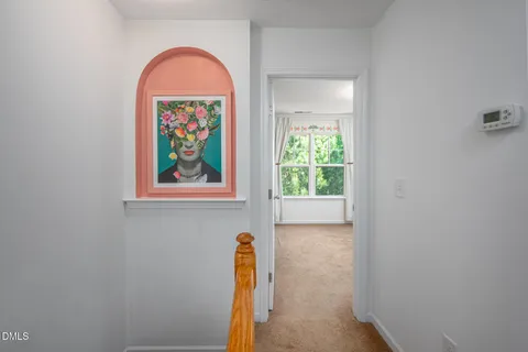 an empty room with windows and wooden floor