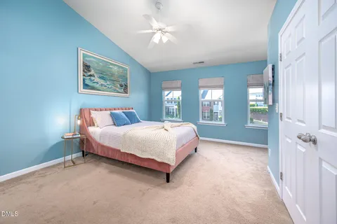 a spacious bedroom with a bed and a chandelier