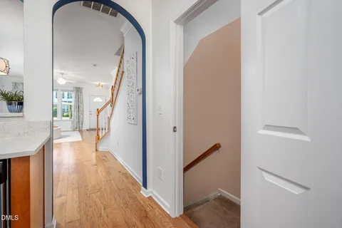 a view of a hallway with wooden floor and staircase