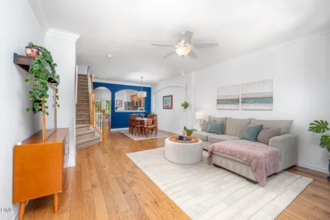 a living room with furniture and a chandelier