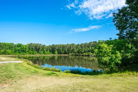 a view of a lake with a house in the background