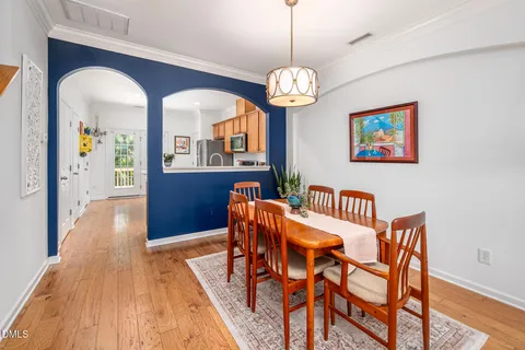 a view of a dining room with furniture wooden floor and chandelier