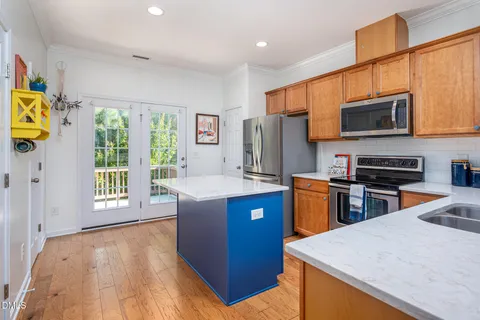a kitchen with stainless steel appliances granite countertop a refrigerator stove microwave and sink