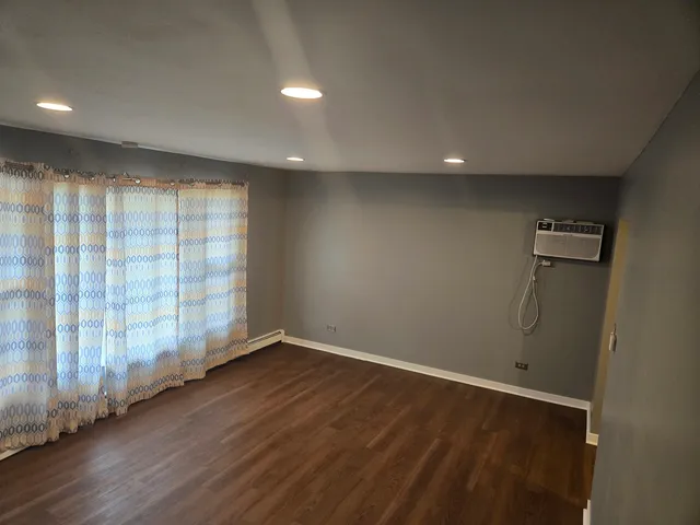 a bathroom with a sink a toilet a mirror a vanity and a shower