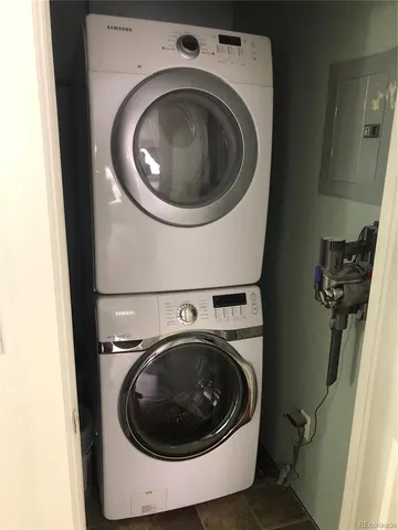 a kitchen with granite countertop a stove a microwave and wooden floor