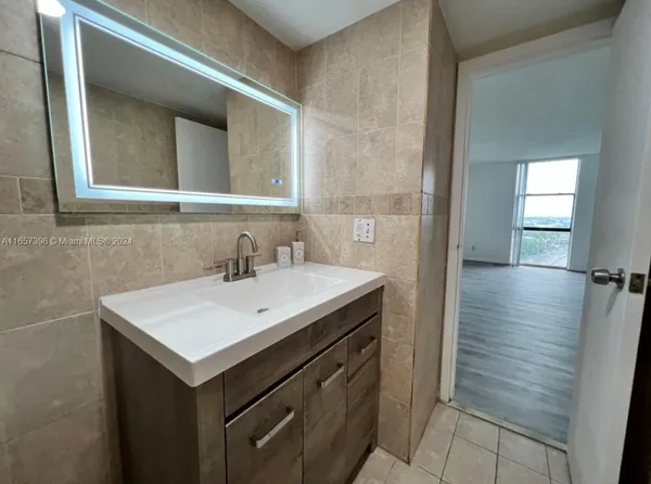 a bathroom with a sink and a mirror
