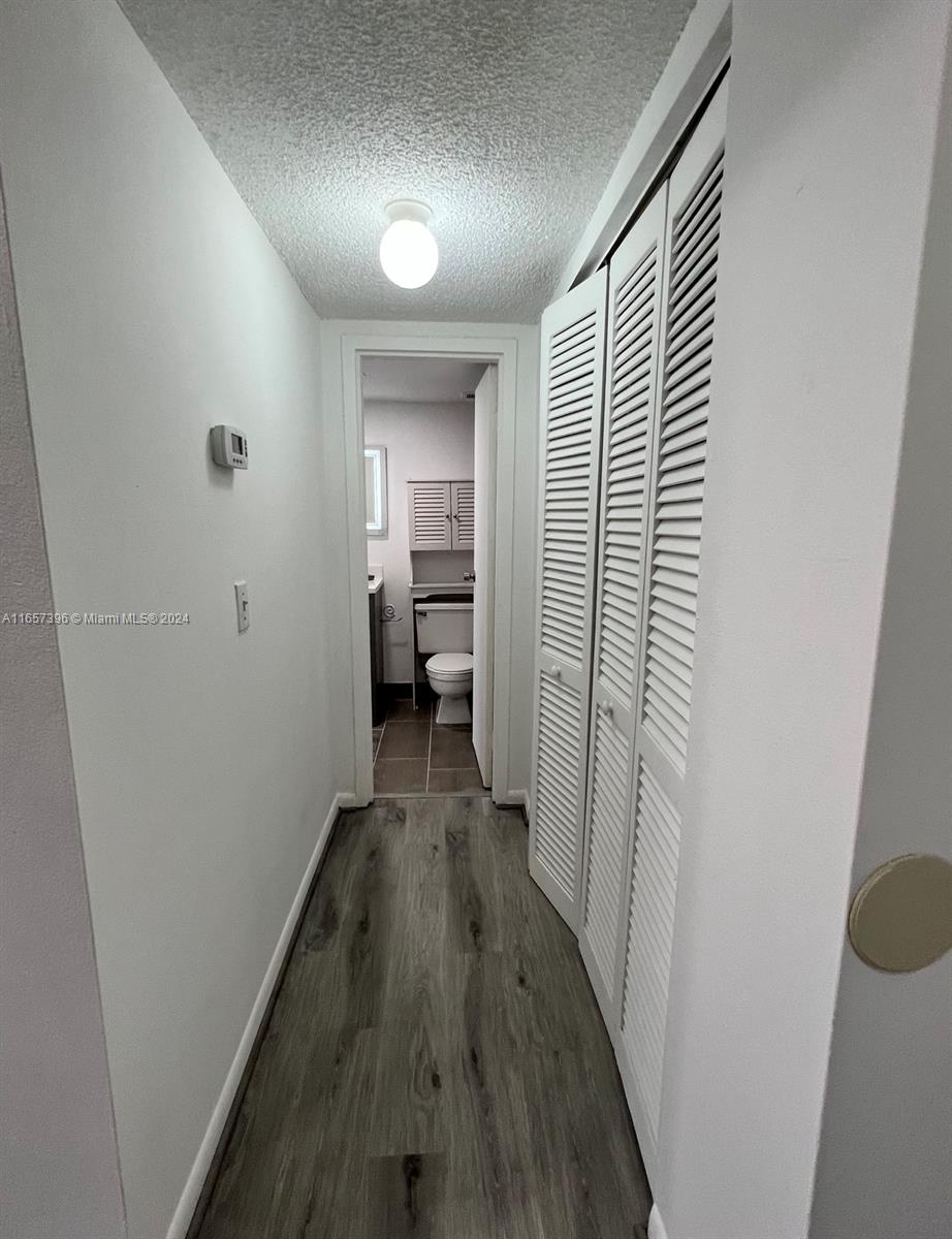13499 Biscayne Boulevard, Unit 1205 North Miami, FL 33181 - Photo 10 of 32 a view of a hallway with wooden floor windows and a bathroom