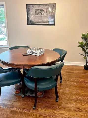 a view of a dining room with furniture and wooden floor