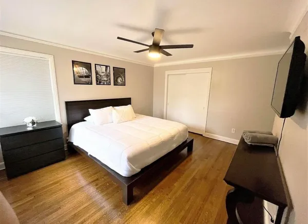 a bedroom with a bed and a flat screen tv