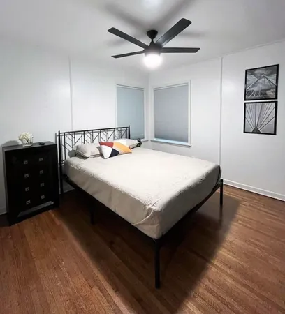 a bedroom with a bed and a dresser