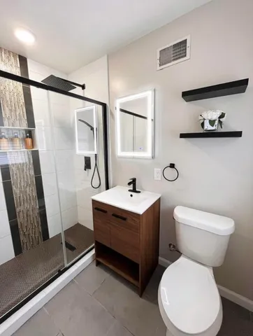 a bathroom with a toilet sink and mirror