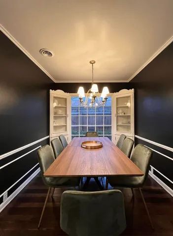 a view of a dining room with furniture and chandelier