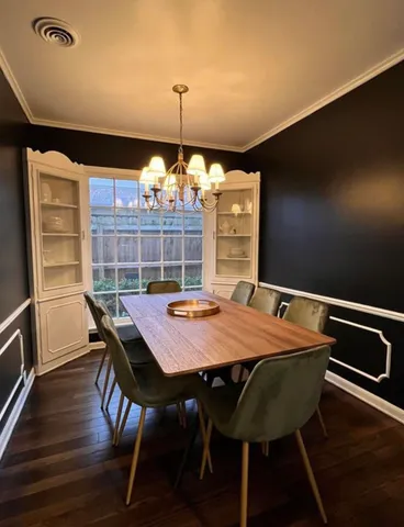 a view of a dining room with furniture and chandelier