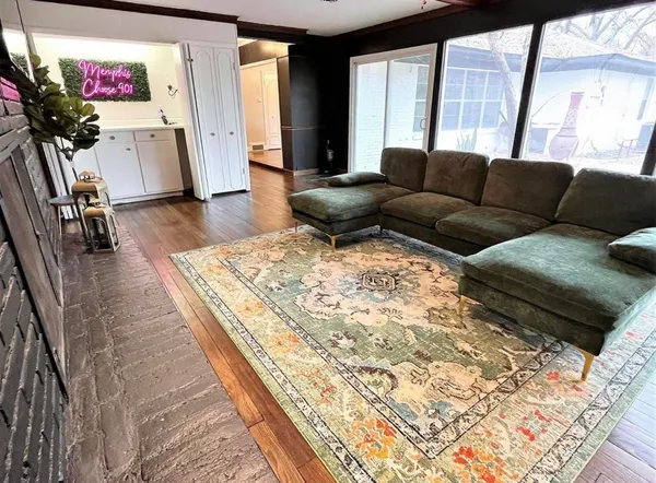 a living room with furniture bathtub and a large window