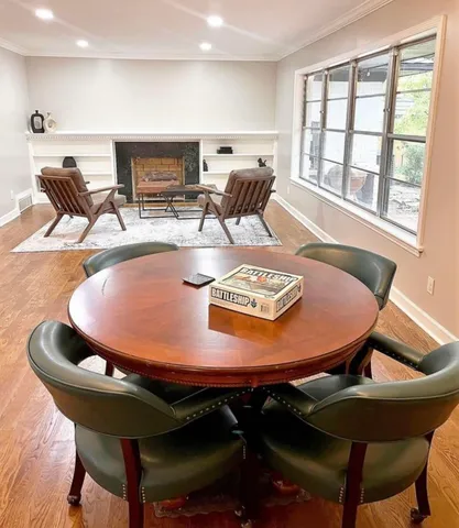 a dining room with furniture and wooden floor