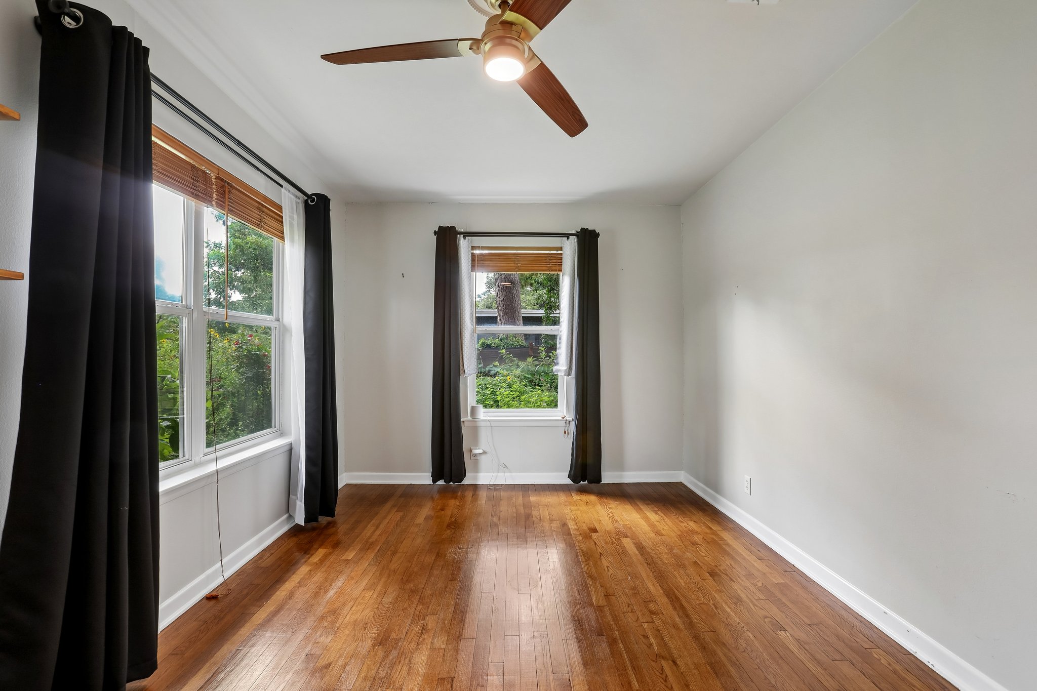 1114 West 2nd Street Elgin, TX 78621 - Photo 10 of 31 Warm hardwood floors and abundant natural light define this inviting living space.