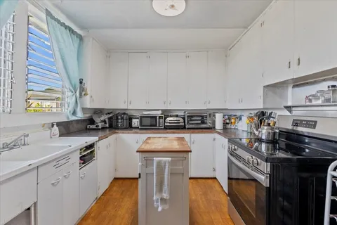 a kitchen with a sink appliances and cabinets