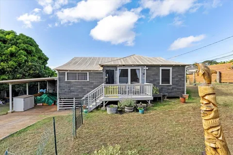 a view of a house with a backyard
