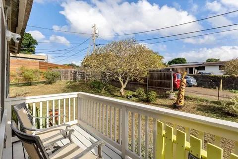 a view of a balcony with chairs
