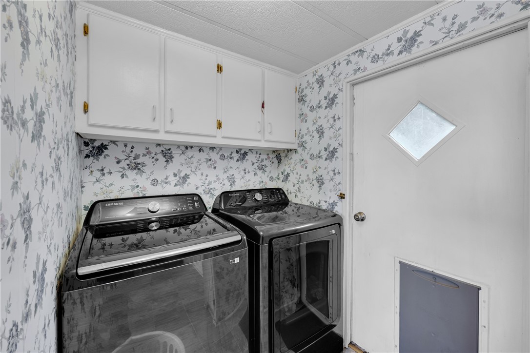 150 Newberry Road Walhalla, SC 29691 - Photo 14 of 47 Ample storage solutions and modern appliances define this well-appointed laundry space.