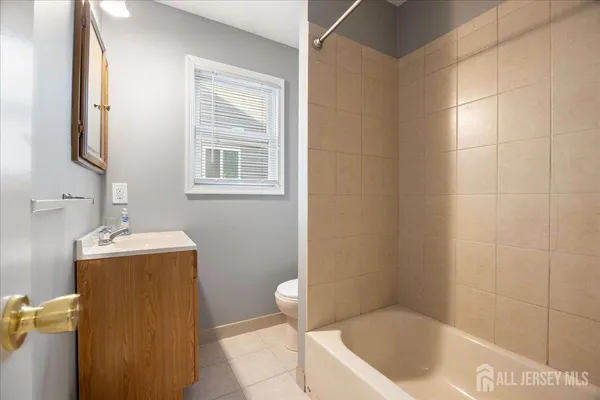 a bathroom with a tub sink and vanity