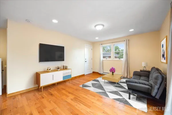 a living room with furniture and a flat screen tv