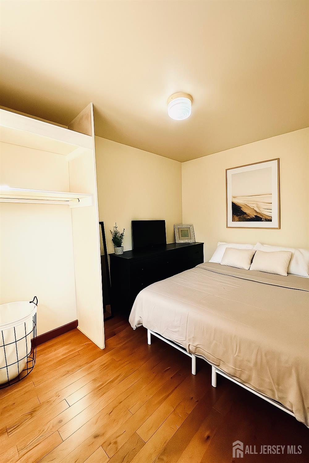 281 Prospect Avenue Old Bridge, NJ 08879 - Photo 17 of 29 a bedroom with a bed and wooden floor