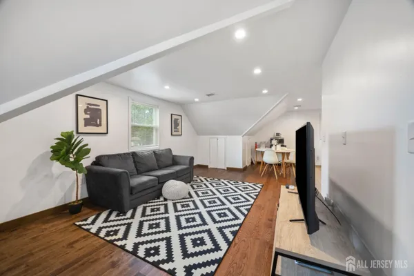 a living room with furniture and a rug