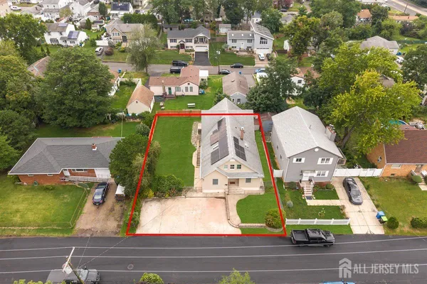 an aerial view of residential houses with outdoor space