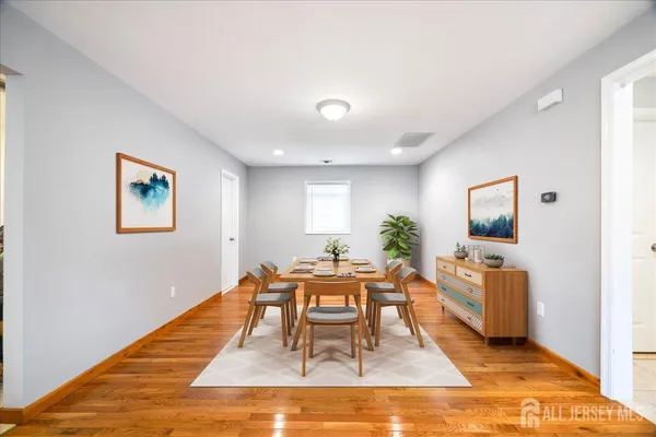 a living room with dining room and wooden floor