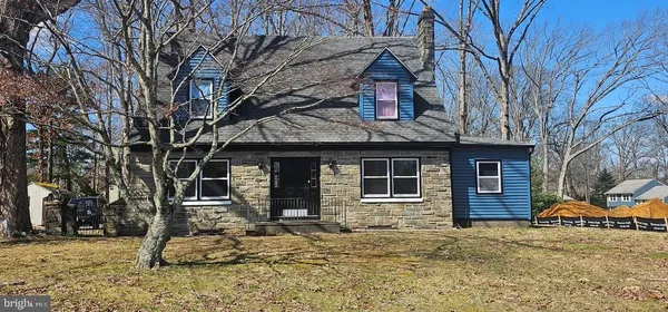 a front view of a house with a yard covered in snow