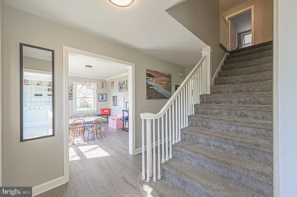 a view of entryway and hall with wooden floor