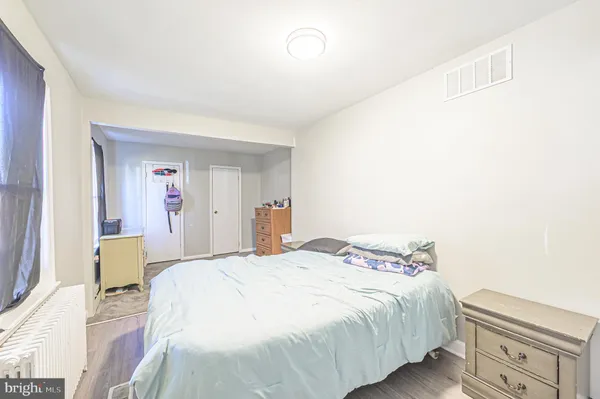a spacious bedroom with a bed and a window