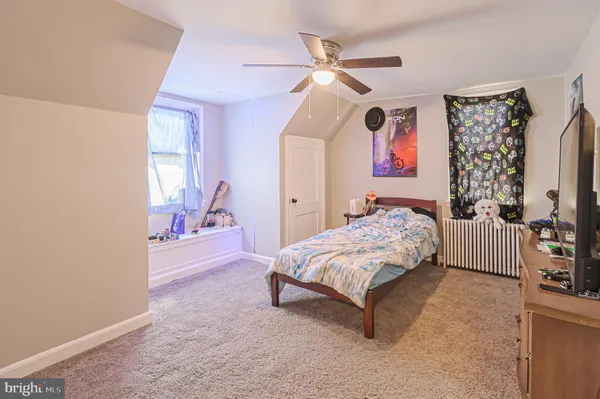a bedroom with a bed couch and a window