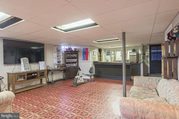 a living room with furniture a flat screen tv and a table