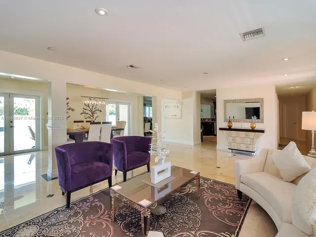 a living room with furniture wooden floor and a large window