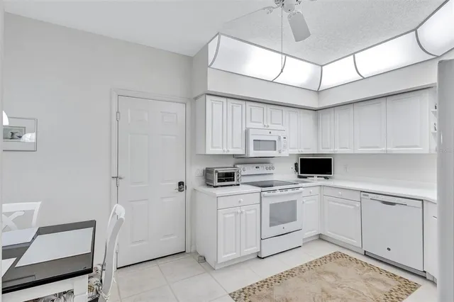 a kitchen with a sink a microwave and cabinets