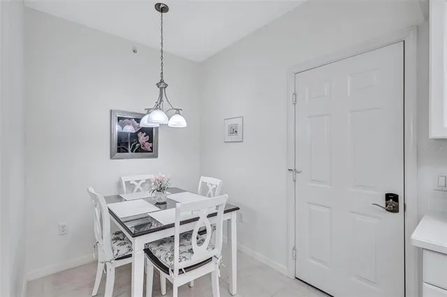 a dining room with a table and chairs