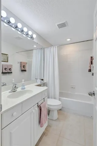 a bathroom with a double vanity sink toilet and shower