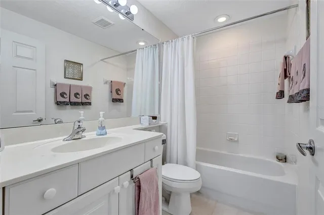 a bathroom with a sink toilet a mirror and shower