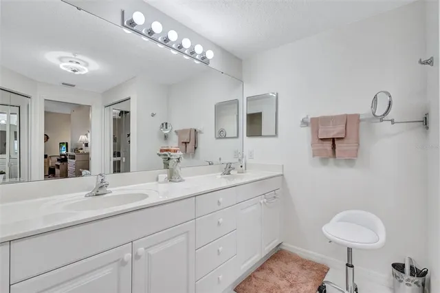 a en suite bathroom with double sink a mirror and a toilet