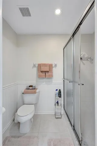 a bathroom with a toilet a sink and shower