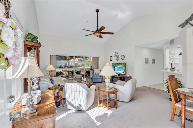 a living room with furniture a rug and white walls