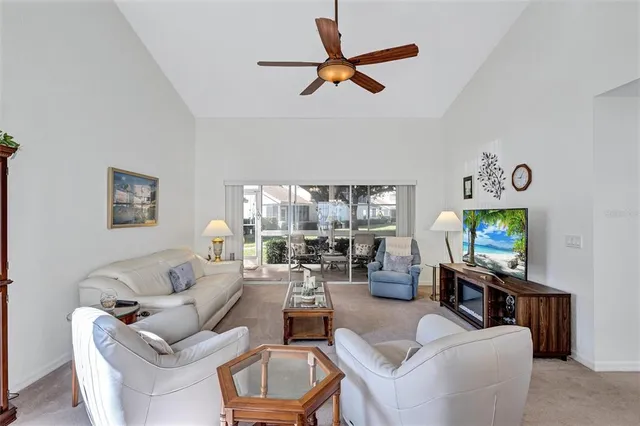 a living room with furniture a window and a flat screen tv