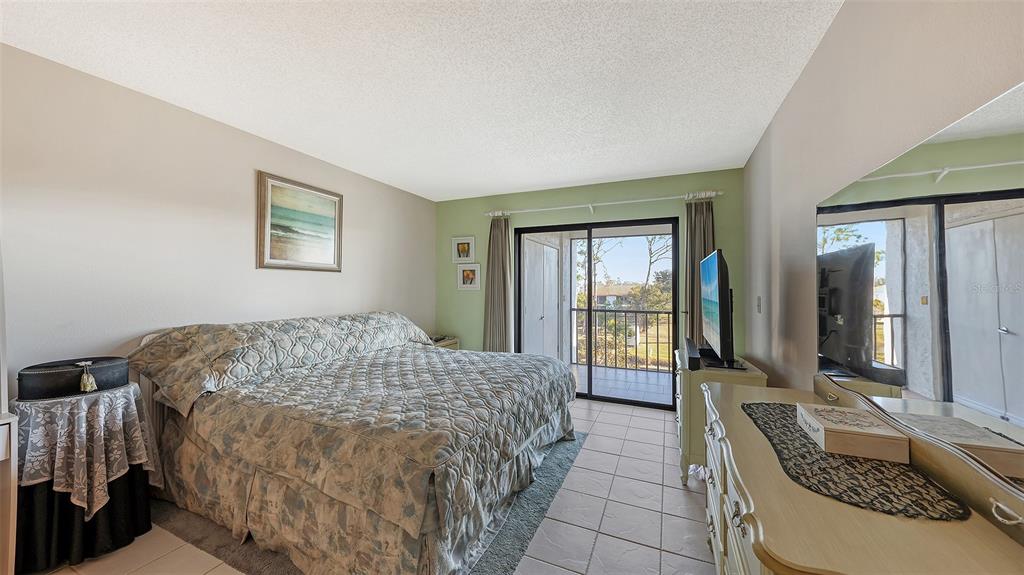 1196 Bird Bay Way, Unit 310 Venice, FL 34285 - Photo 14 of 37 a bed sitting in a bedroom next to a window