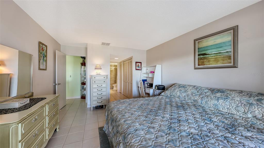 1196 Bird Bay Way, Unit 310 Venice, FL 34285 - Photo 15 of 37 a bedroom with a bed and a dresser