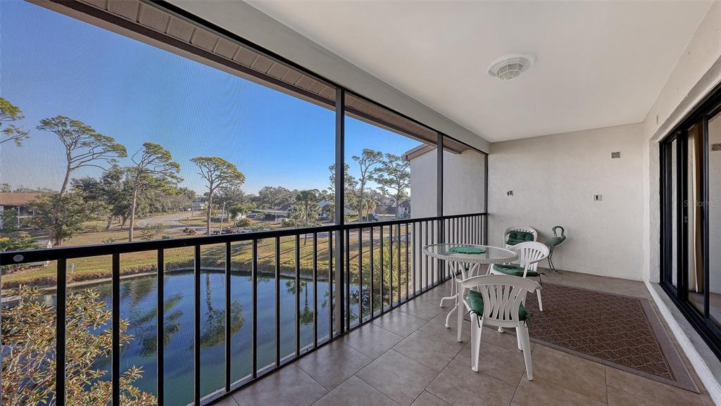 1196 Bird Bay Way, Unit 310 Venice, FL 34285 - Photo 18 of 37 a view of a chairs and table in a balcony